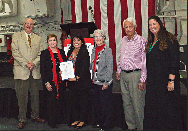 Mom-San Diego recently received a $25,000 grant from the USS Midway Foundaiton. Seen here, Barbara Chvez, executive Director, show the award. From left to right, John Doe, Jane Doe, Barbara Chavez, Ellen Doe, Mark Doe and Foundation President Ella Doe